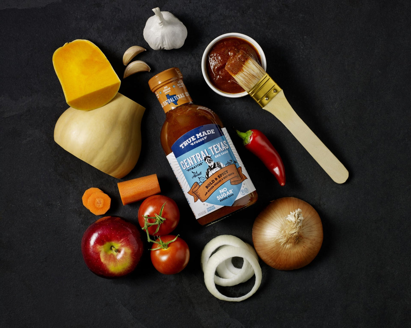 Central Texas Style BBQ sauce by True Made Foods with fresh vegetables, highlighting sugar-free grilling.